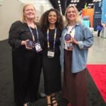 Event attendees holding personalized hand-painted coasters