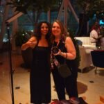 Artist presenting personalized coasters to guests at an event